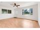 Bright living room featuring wood-look floors, white walls, a ceiling fan and natural light at 1109 Hampton St, Clermont, FL 34711