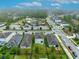 Community aerial view featuring a pool, surrounding houses and street in a neighborhood with verdant green space at 113 Camilla Rd, Deland, FL 32724