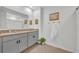 Bathroom with granite counters, double sinks, grey cabinetry, and decorative hardware and decor at 113 Camilla Rd, Deland, FL 32724