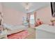 Bright and airy bedroom featuring pink walls, chandelier, decor, and natural light at 113 Camilla Rd, Deland, FL 32724
