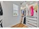 Organized walk-in closet featuring custom shelves, rods, and drawers for storing clothing and accessories at 113 Camilla Rd, Deland, FL 32724