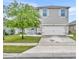 Two-story home with neutral paint, white trim, and neat landscaping creating curb appeal at 113 Camilla Rd, Deland, FL 32724