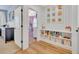 Hallway with built-in shelving and cubbies leading to a pink bedroom creating a cozy and organized space at 113 Camilla Rd, Deland, FL 32724