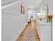 Bright hallway with wood floors, decorative mirror and lamps, leading to the dining and living areas at 113 Camilla Rd, Deland, FL 32724