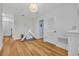 Hallway with wood floors, a teepee, and three doorways at 113 Camilla Rd, Deland, FL 32724