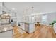 Open kitchen and dining area featuring granite countertops, stainless steel appliances, and hardwood floors at 113 Camilla Rd, Deland, FL 32724