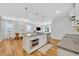 Open concept kitchen with a large island and wood floors, seamlessly flowing into the dining and living areas at 113 Camilla Rd, Deland, FL 32724