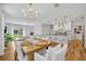 Open-concept living space with hardwood floors, featuring a dining area, kitchen, and living room at 113 Camilla Rd, Deland, FL 32724