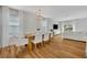 Open-concept living space with hardwood floors, large windows, and modern white furnishings at 113 Camilla Rd, Deland, FL 32724