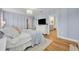 Spacious main bedroom with soft blue walls, wood floors, a ceiling fan and an ensuite bathroom at 113 Camilla Rd, Deland, FL 32724