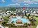 Aerial view of a community pool with lounge chairs and a clubhouse at 113 Camilla Rd, Deland, FL 32724