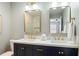 Bathroom with double sinks, white quartz countertops, and gold hardware at 1208 Santa Cruz Dr, The Villages, FL 32162