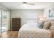 Bedroom with a view to the outside, and features a wood dresser at 1208 Santa Cruz Dr, The Villages, FL 32162