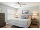 Cozy bedroom with a ceiling fan, light green walls, and wood-look flooring at 1208 Santa Cruz Dr, The Villages, FL 32162