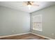 This bedroom is airy and bright, with a ceiling fan and window at 1208 Santa Cruz Dr, The Villages, FL 32162