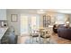 The dining area features a table and chairs near the kitchen, with a view of the living room at 1208 Santa Cruz Dr, The Villages, FL 32162