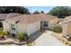 Charming home features a well-maintained lawn, lovely landscaping, and a two-car garage at 1208 Santa Cruz Dr, The Villages, FL 32162