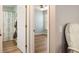 Hallway leading to bedroom features neutral walls and wood-look floors at 1208 Santa Cruz Dr, The Villages, FL 32162