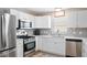The modern kitchen boasts stainless steel appliances and gray backsplash at 1208 Santa Cruz Dr, The Villages, FL 32162
