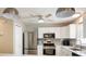 The kitchen is fully equipped with stainless steel appliances and a microwave at 1208 Santa Cruz Dr, The Villages, FL 32162