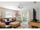 This is an open living room with a plush sofa and lots of light at 1208 Santa Cruz Dr, The Villages, FL 32162