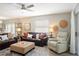 This living room features a leather sofa, recliner, and ottoman at 1208 Santa Cruz Dr, The Villages, FL 32162