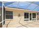 Spacious outdoor patio with a screen enclosure, ideal for enjoying the outdoors at 1208 Santa Cruz Dr, The Villages, FL 32162