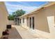 Covered patio features white framed doors and a retractable awning for added shade and comfort at 1208 Santa Cruz Dr, The Villages, FL 32162