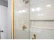 Modern shower with white subway tile and gold trim at 1208 Santa Cruz Dr, The Villages, FL 32162