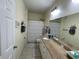 Bathroom features a single sink vanity, a shower-tub combo, and decorative shelving at 130 Southern Pecan # 105, Winter Garden, FL 34787