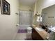 This full bathroom features a shower-tub combo, granite vanity, and neutral tile floors at 130 Southern Pecan # 105, Winter Garden, FL 34787