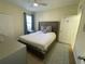 Comfortable bedroom with a tufted headboard, closet, and natural light from the window at 130 Southern Pecan # 105, Winter Garden, FL 34787