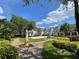 Beautiful community grounds with landscaped flower beds, sidewalks, benches, and attractive residential architecture at 130 Southern Pecan # 105, Winter Garden, FL 34787
