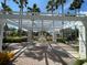 Beautiful courtyard featuring a fountain, manicured landscaping, and a shaded pergola at 130 Southern Pecan # 105, Winter Garden, FL 34787