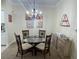 Cozy dining room featuring stylish decor, chandelier lighting, and a glass-top table at 130 Southern Pecan # 105, Winter Garden, FL 34787