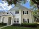 Charming two-story townhouse featuring a well-maintained lawn and inviting facade at 130 Southern Pecan # 105, Winter Garden, FL 34787