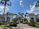 Beautiful community clubhouse featuring tropical landscaping and brick paver walkways at 130 Southern Pecan # 105, Winter Garden, FL 34787