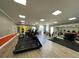 Bright, well-equipped fitness center featuring treadmills, weights, machines, and a mirrored wall at 130 Southern Pecan # 105, Winter Garden, FL 34787