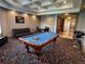 Spacious game room with a pool table, a small seating area, and unique confetti patterned carpet at 130 Southern Pecan # 105, Winter Garden, FL 34787