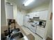 Efficient kitchen with white appliances and cabinetry, along with granite countertops at 130 Southern Pecan # 105, Winter Garden, FL 34787