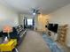 Inviting living room with comfortable seating, ceiling fan, and a view into an office space at 130 Southern Pecan # 105, Winter Garden, FL 34787