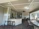 Inviting outdoor bar area with granite countertops, seating, and plenty of space for entertaining at 130 Southern Pecan # 105, Winter Garden, FL 34787
