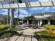 Charming patio area with seating, lush landscaping, and barbecue grills at 130 Southern Pecan # 105, Winter Garden, FL 34787