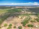 Wide aerial shot of a large rural property with fields, forest, and scattered homes, offering serene country living at 13013 County Road 561A, Clermont, FL 34715