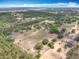 Aerial view of a sprawling estate featuring a mix of open land and lush forestry, perfect for nature lovers at 13013 County Road 561A, Clermont, FL 34715