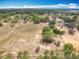 A landscape showcasing verdant trees interspersed amidst expansive farmland, offering serene seclusion at 13013 County Road 561A, Clermont, FL 34715