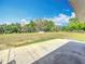 Expansive backyard view, showcasing lush greenery and an open field, perfect for outdoor activities at 13013 County Road 561A, Clermont, FL 34715
