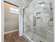 Bathroom featuring a glass-enclosed shower with marble walls and mosaic flooring at 13013 County Road 561A, Clermont, FL 34715
