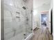 Modern bathroom featuring a glass shower with marble tile and a built-in shower niche at 13013 County Road 561A, Clermont, FL 34715