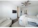 Bright bedroom featuring a ceiling fan, a cozy chair, and a comfortable-looking bed with plush bedding at 13013 County Road 561A, Clermont, FL 34715